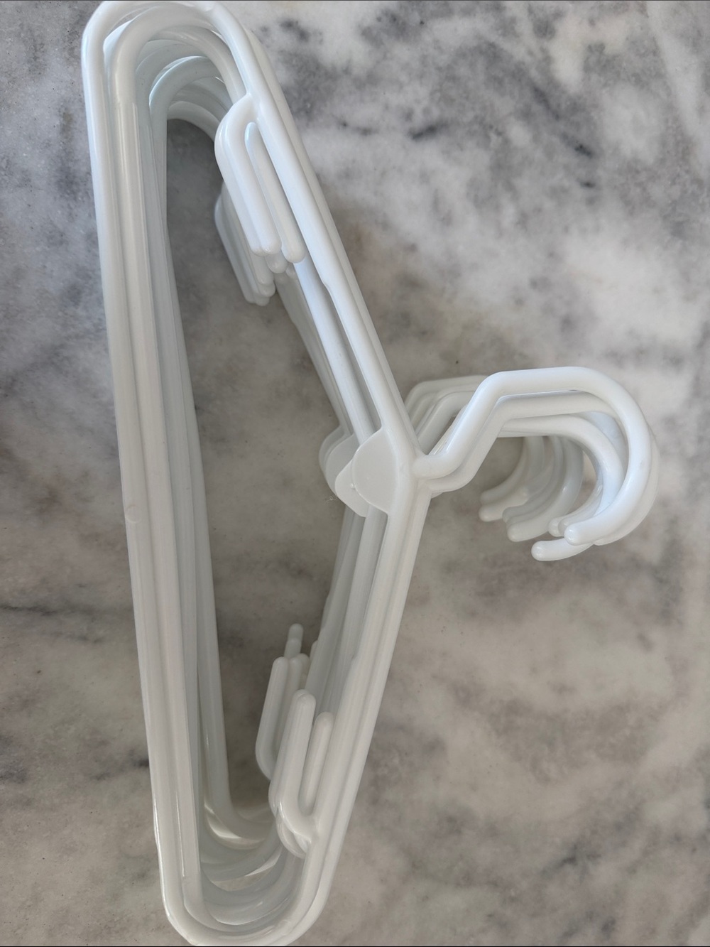 Set if 13 white plastic baby hangers